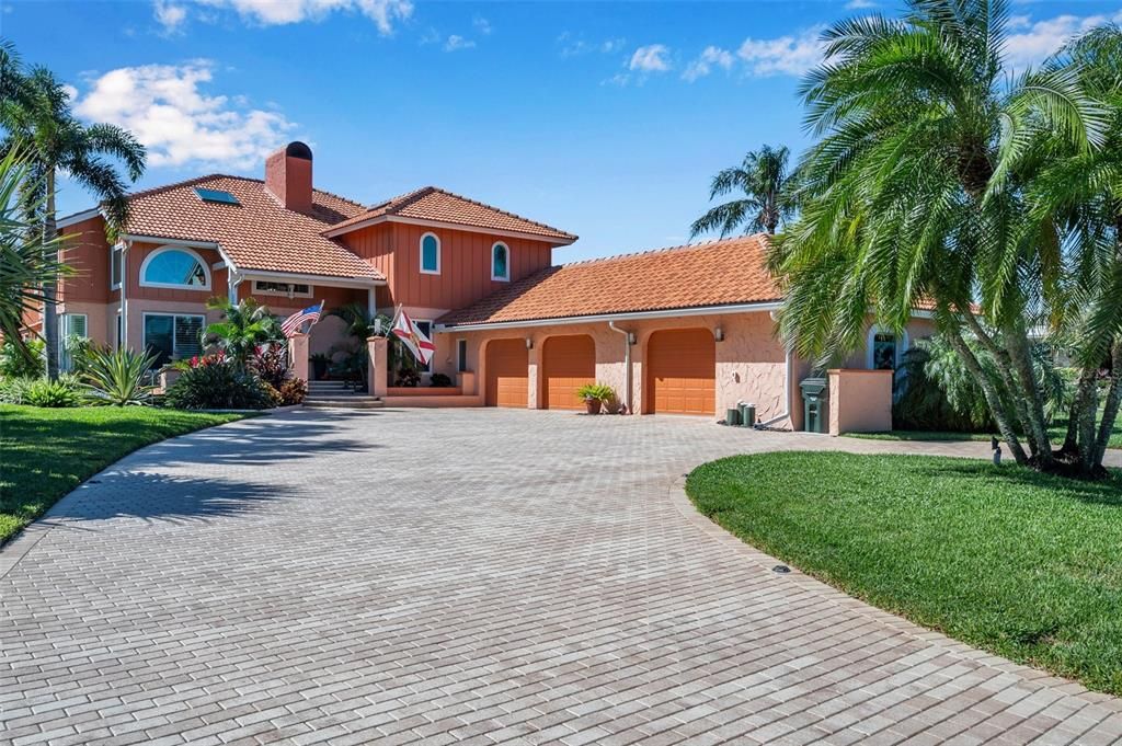 Fabulous curb appeal with side entry oversized three car garage with workshop epoxy floors and mini-split AC