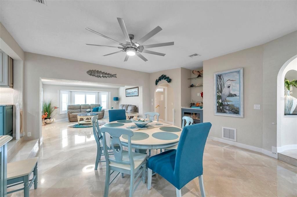 The dining room shares the same marble flooring with the family room