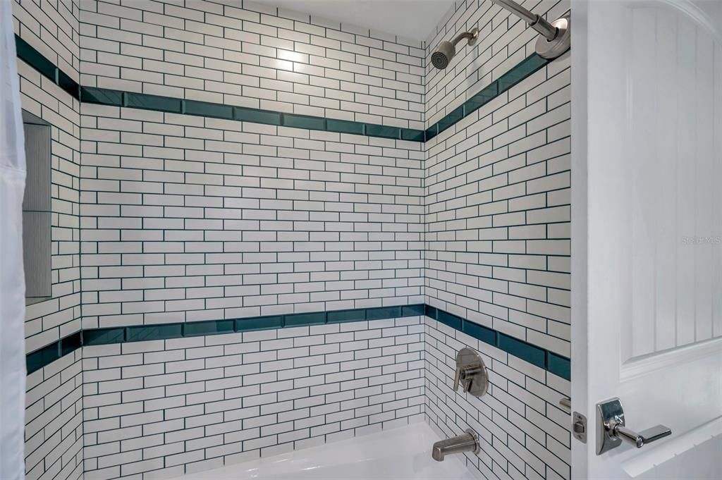 Features a subway tile tub shower combo