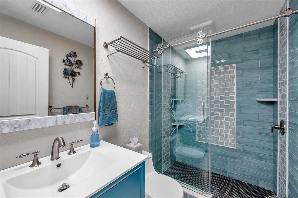 The downstairs features this beautiful full bathroom along with a half bathroom