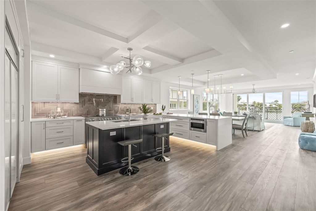 The kitchen overlooks the dining/living room and out to the balcony overlooking the water.