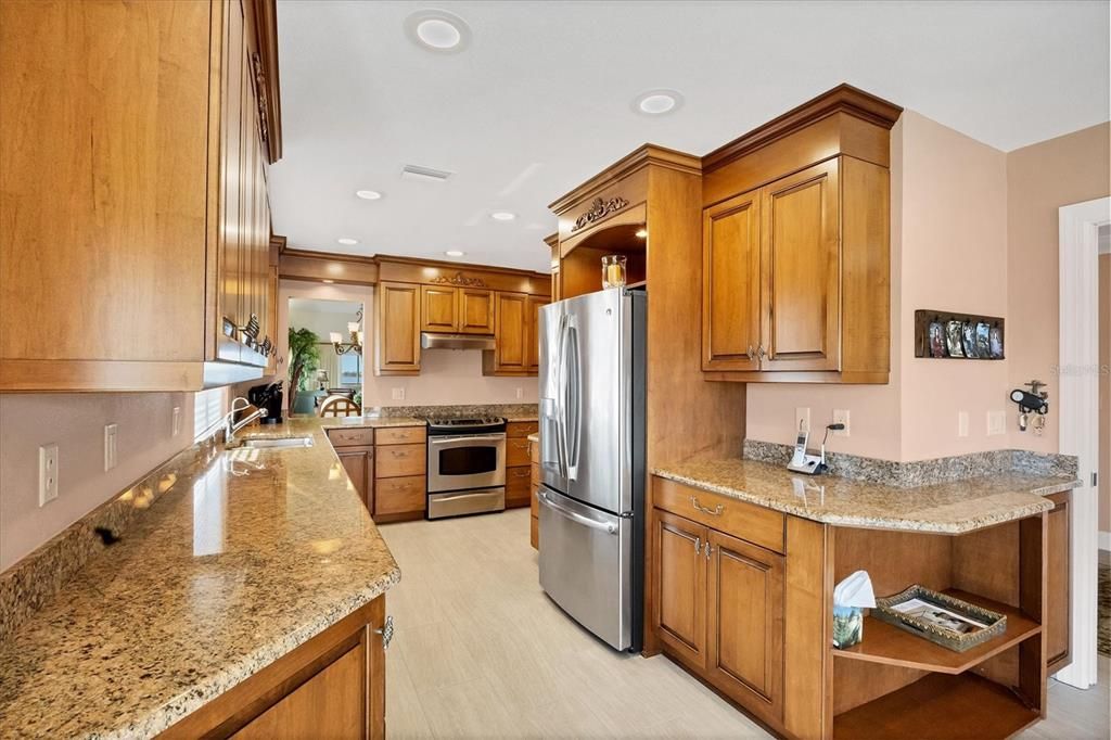 Kitchen is highlighted with granite & stainless appliances