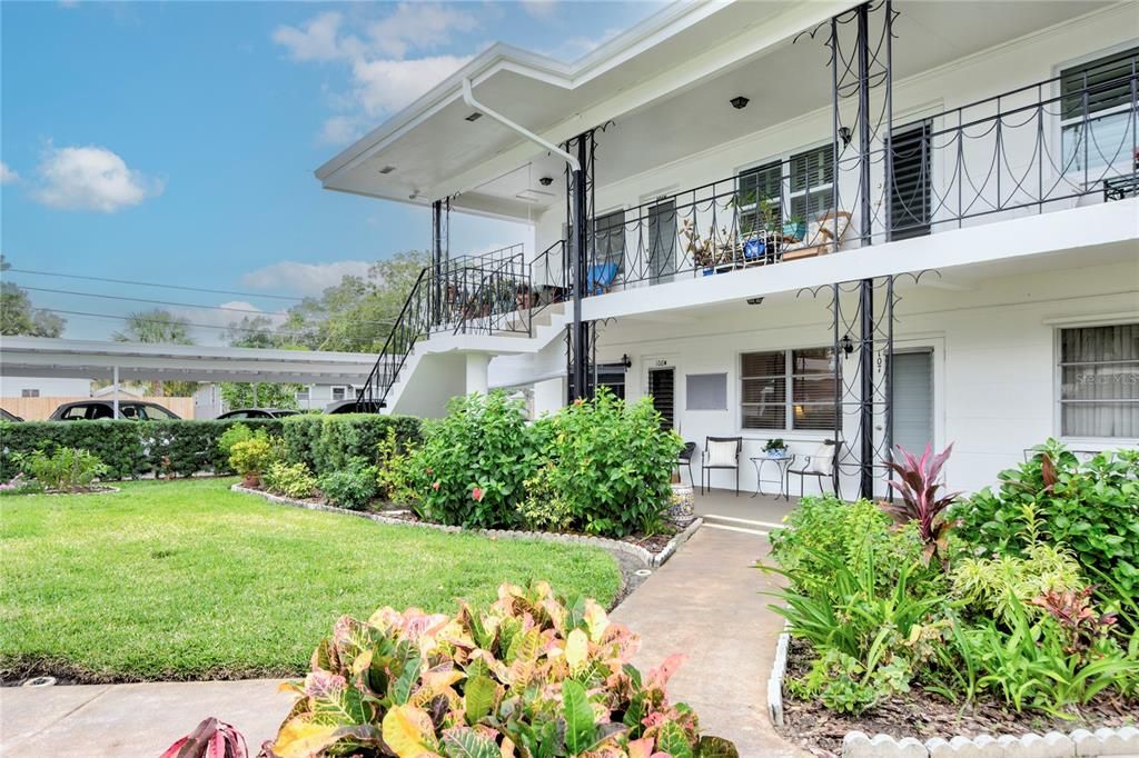 Walk up entrance next to carport on the first floor