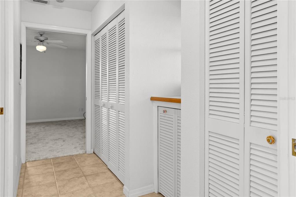 There is a hallway from the Living Area that leads to a Third Bedroom.  There is a shared bathroom, and on the right the Laundry Closet for the home.