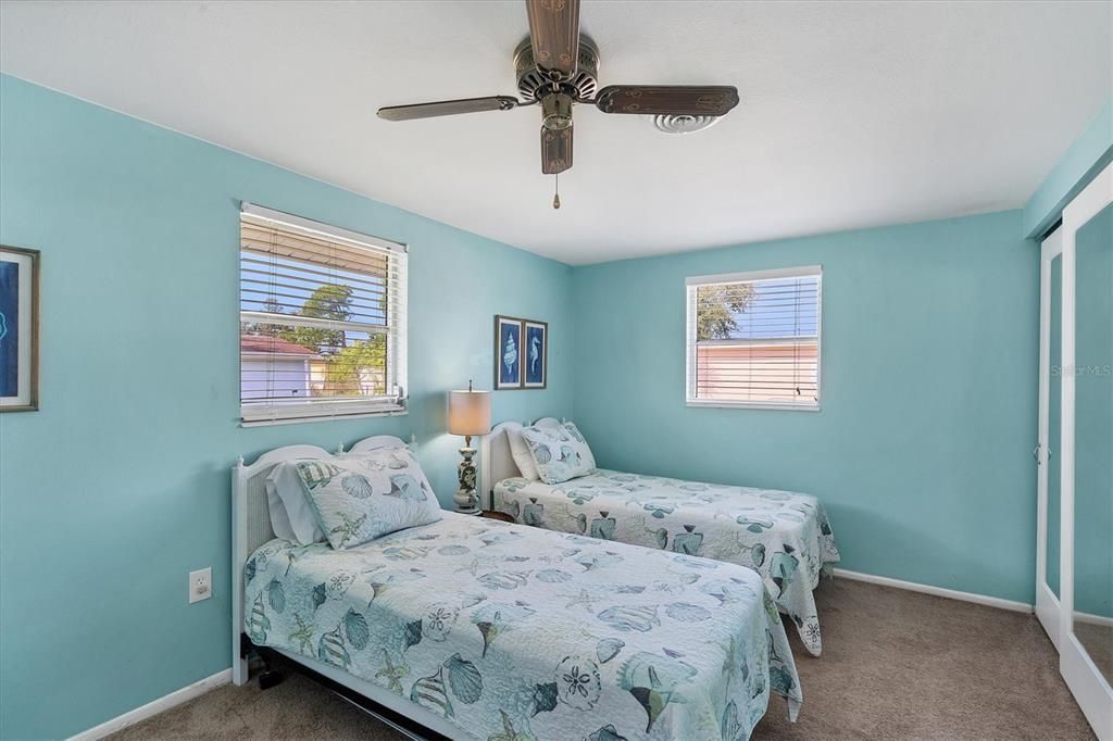 two twin beds in second bedroom