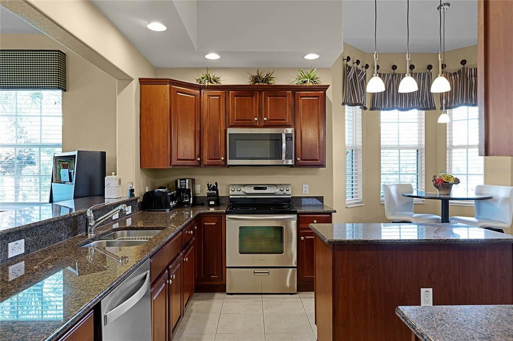 Kitchen has granite countertops and stainless steel appliances