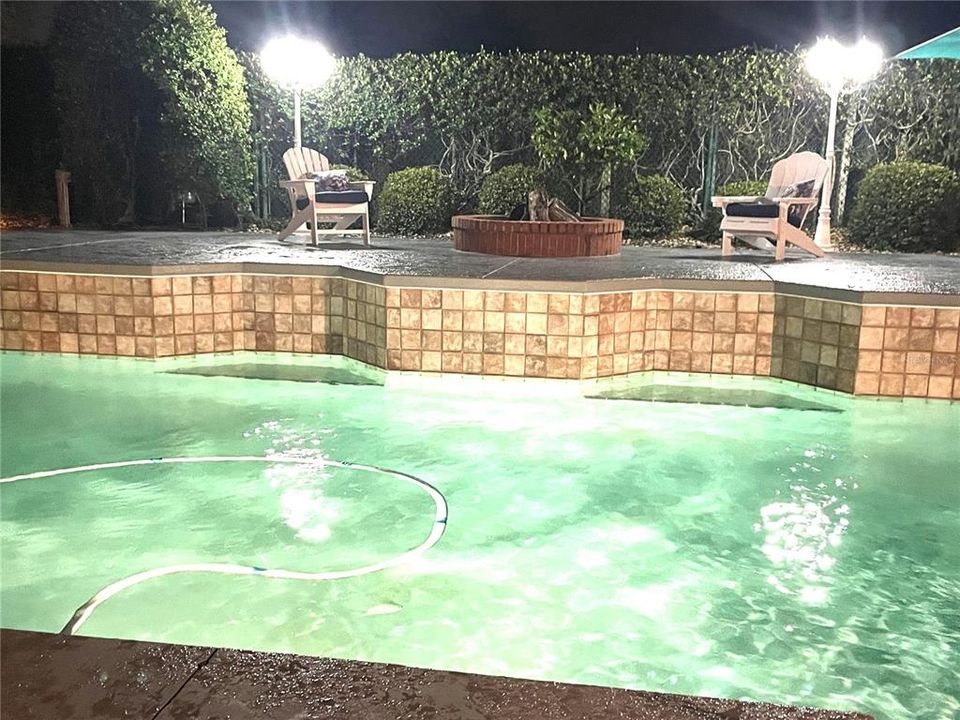 Pool and firepit at night