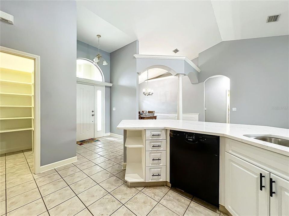 Walk in pantry, foyer and view into the dining room