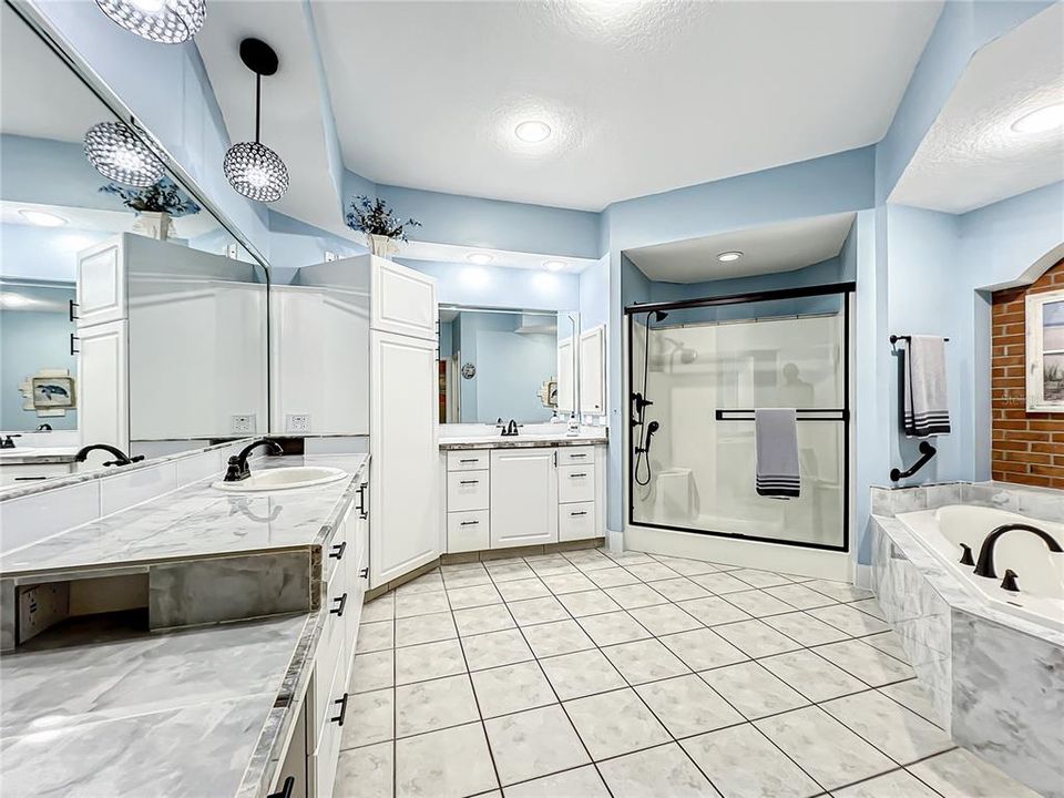 Master bathroom with updated his and hers vanities and updated shower