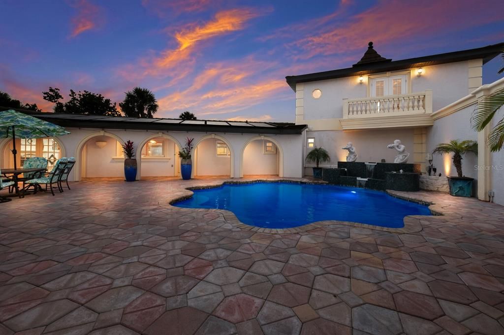 An evening view of the center courtyard, pool and fountains