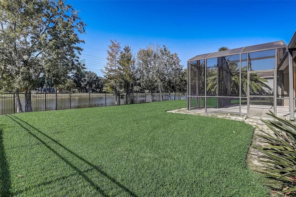Fenced In Backyard with Pond Water View