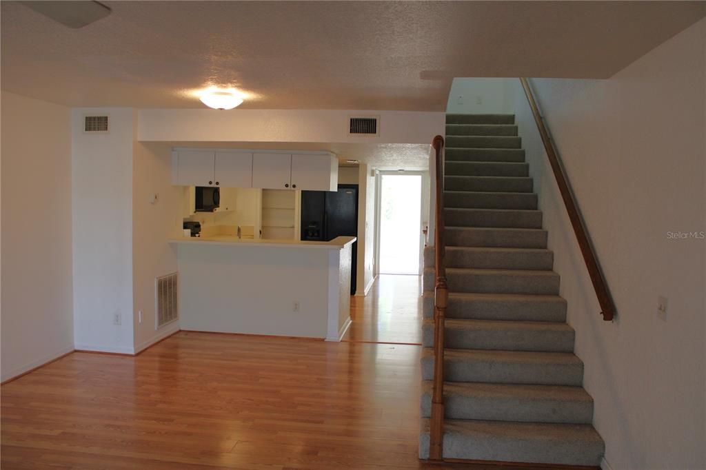 Kitchen and dining area with stairs to third floor