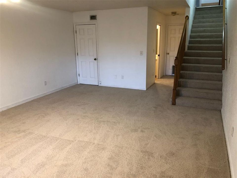 Lower floor bonus room and stairway up to main floor