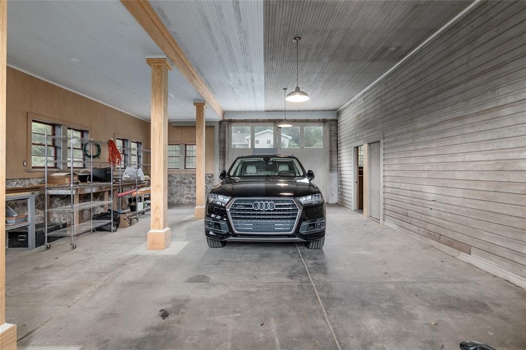 Carriage House with Tandem Parking for 2 cars and golf cart. Featuring, workshop, kitchen, pool bath and stairs to loft.