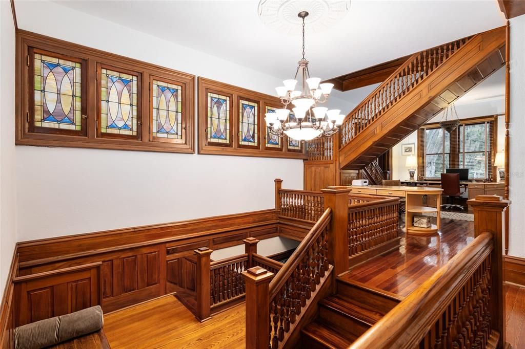 Magnolia Stairwell, cypress window sashes, original hardware and stained-glass windows