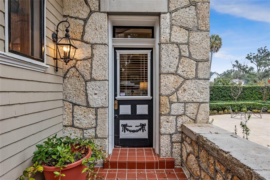 Door off the Dining Room leads outside to large private courtyard showcasing fountain, pool, and gardens