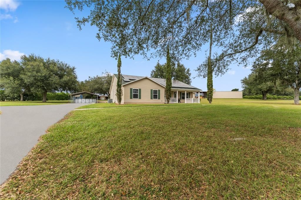 Front of home with extended paved driveway