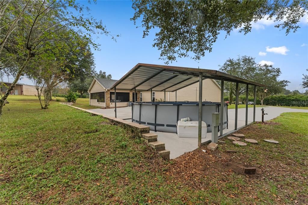 Large covered carport & above ground pool