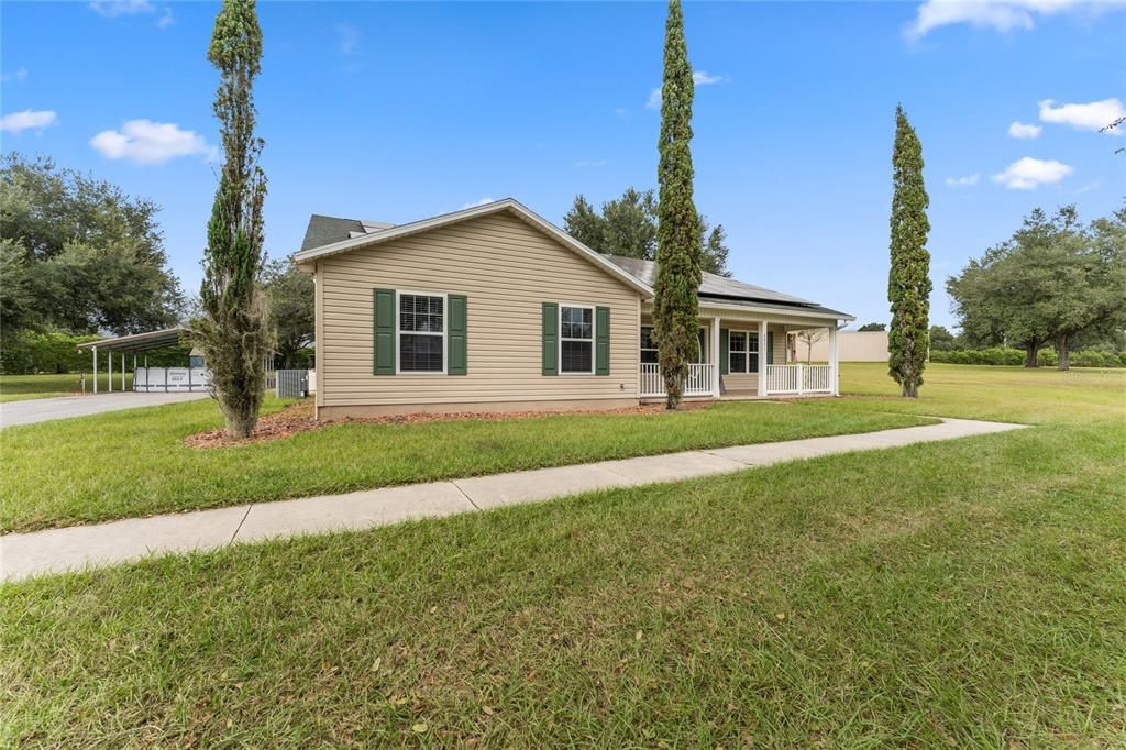 Front of home and sidewalk to side parking area