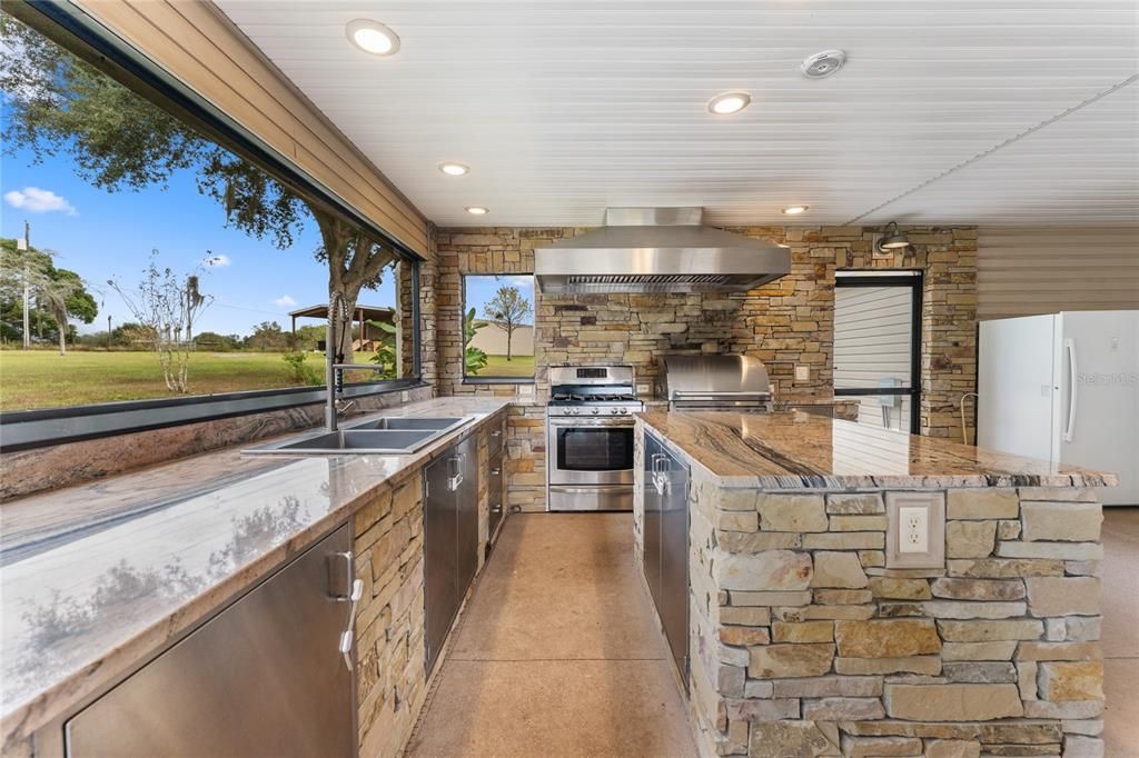 Outdoor kitchen appliances include grill, gas range, freezer & 2nd grill