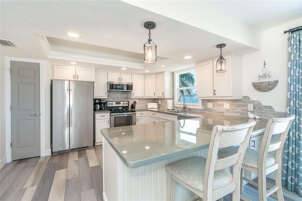 Maybe you would rather sit and enjoy the comfortable counter-bar area. What a great epoxy countertop. It is really stunning. All new appliances plus a pantry in kitchen. Designed with plenty of storage.