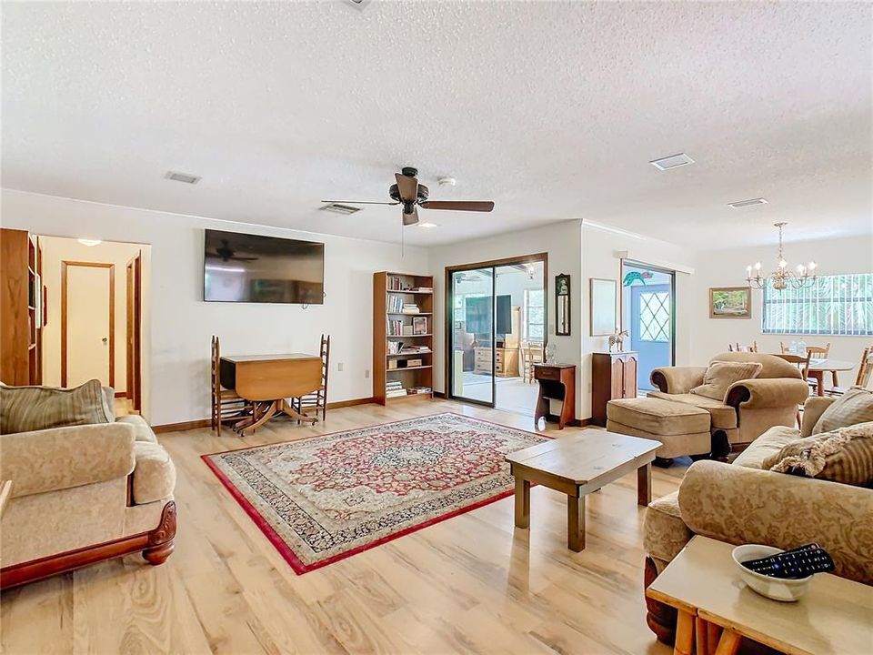 Living room has large open floor plan with dining room to the back right of picture.