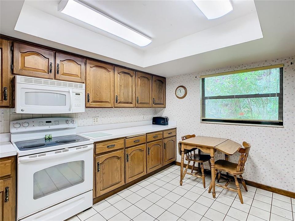 Kitchen has wood cabinets and plenty of counter space.
