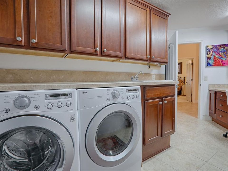 front loading washer and dryer, custom cherry wood cabinets