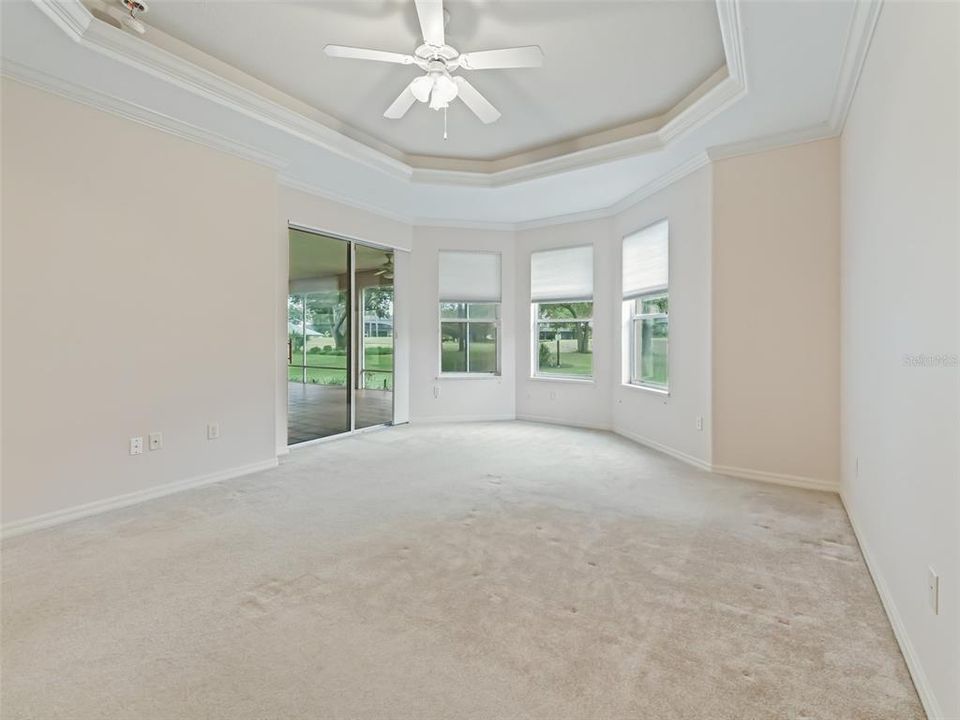 Primary bedroom with large windows and sliding door to lanai