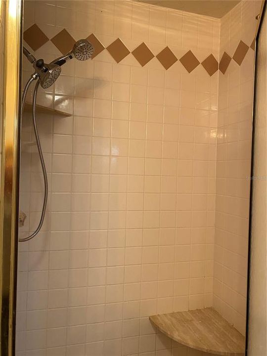 Walk-in shower is tiled