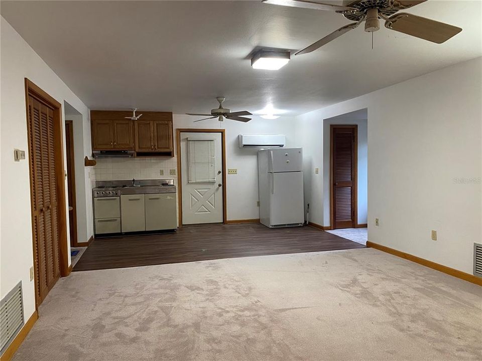 Living room area with kitchenette and dinette area at the far end.