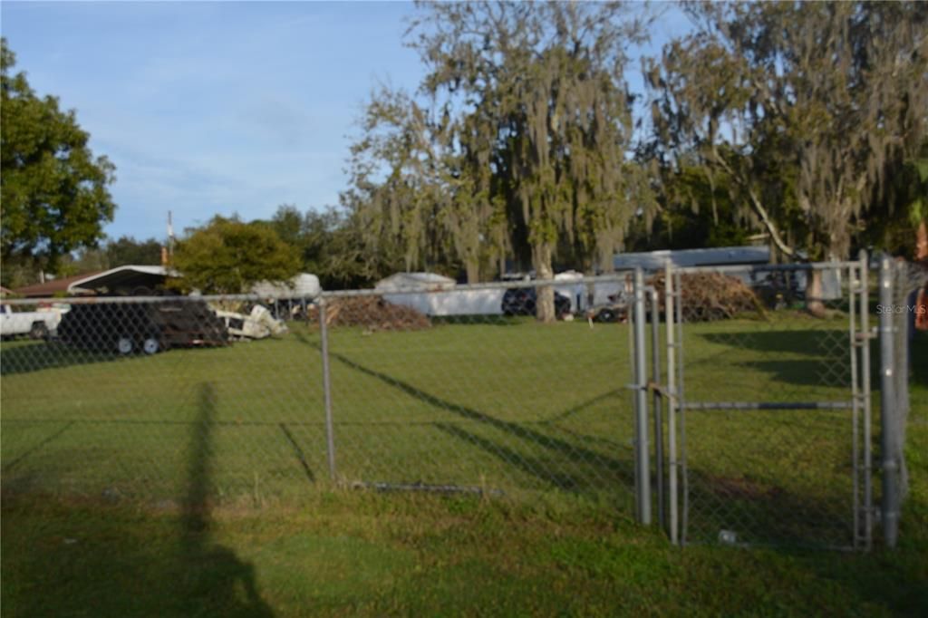 Small gate on the right side of the lot and any items that are on the lot will be removed before closing