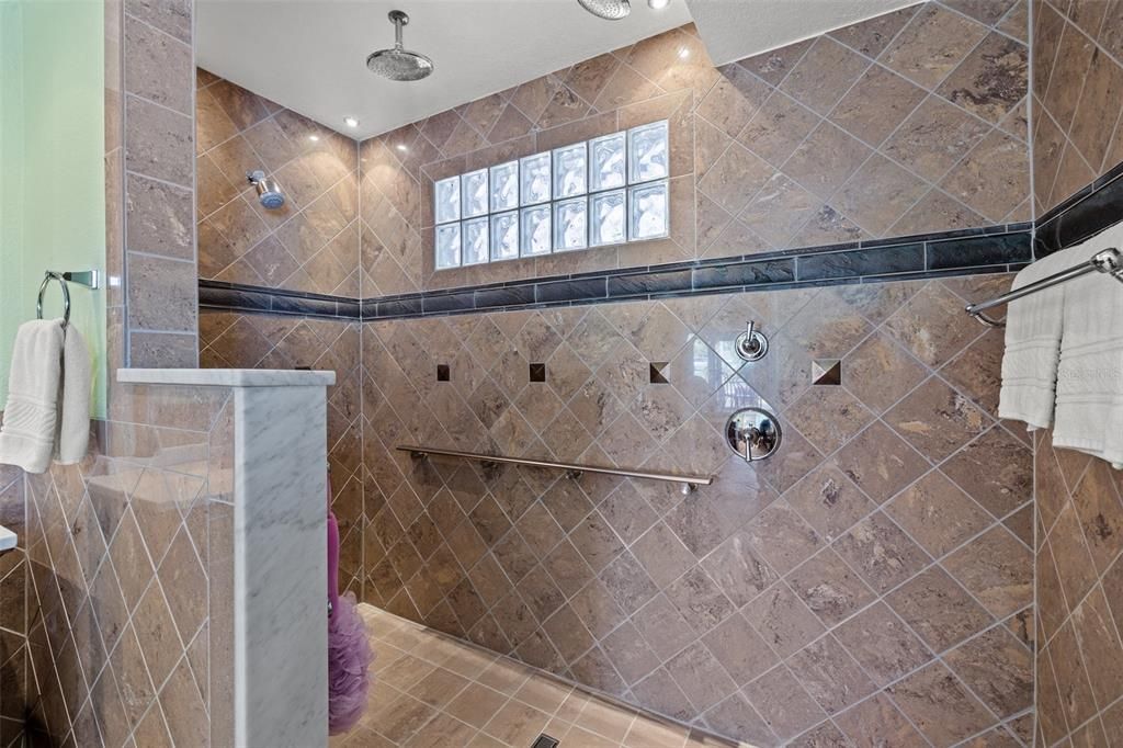 Master bath shower features triple shower heads.