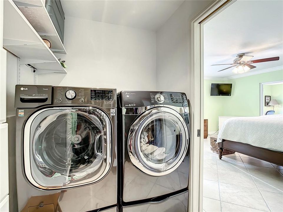LG front load washer and dryer are conveniently located within the master bedroom closet.