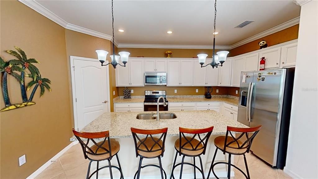Grand Center Island with bar seating and pendant lights