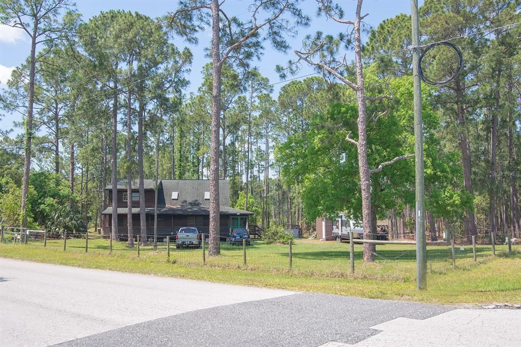 Solar powered electronic gate allows access to the property, with the pond in the distance.