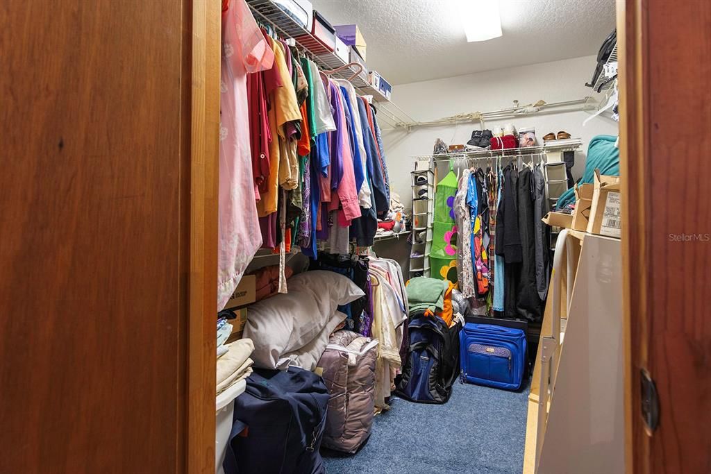 This huge master bedroom walk-in closet has enough room for all your storage needs!