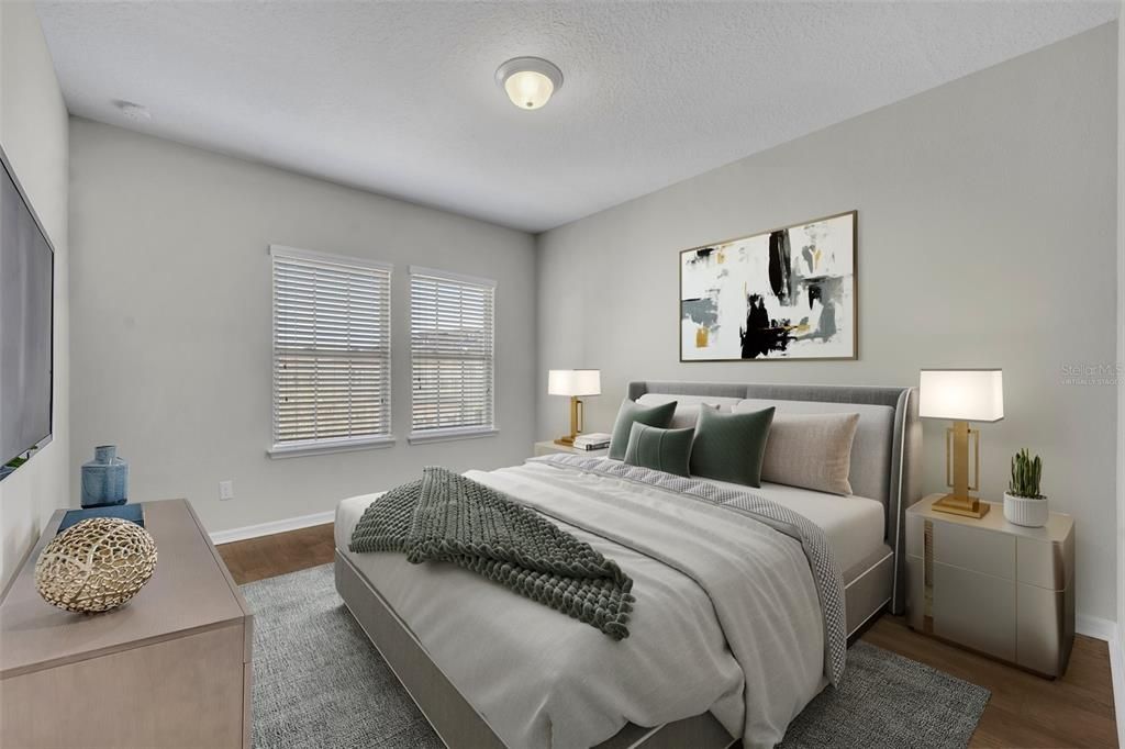 Virtually Staged Photo; Primary/Master Bedroom features an ensuite bath and walk-in closet.
