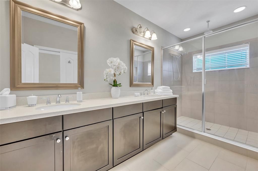 Master en-suite bathroom Stone counter tops, dual sinks & a large walk-in shower featuring a rain shower head and second shower head. This bath also has its own linen closet.