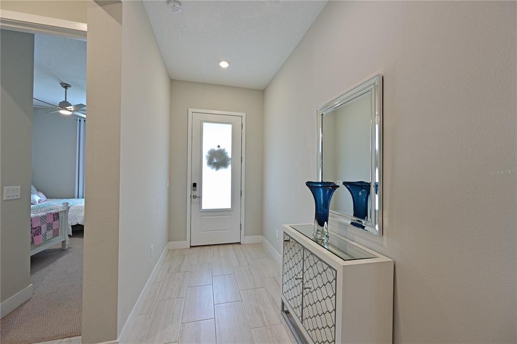 Entry foyer with frosted glass front door to provide natural light in the foyer.