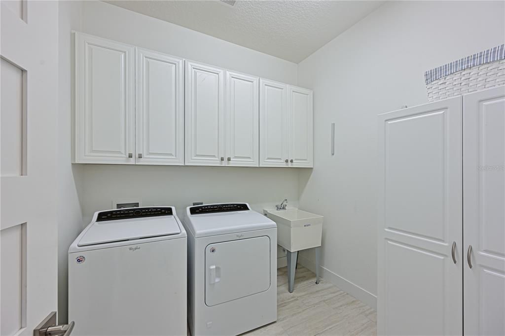 Spacious Laundry Room with utility sink and storage