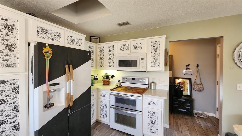 Bar/Kitchen Cabinets. White Cabinets with peel and stick wallpaper.