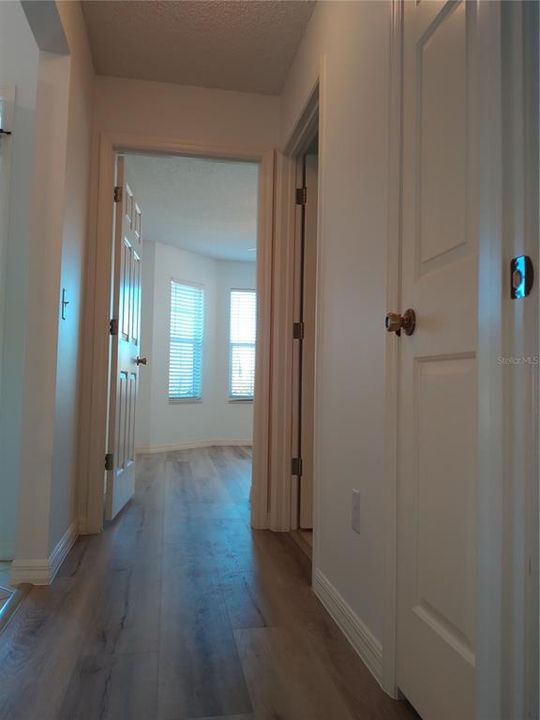 Hallway off foyer, that leads to guest bath, and guest bedrooms