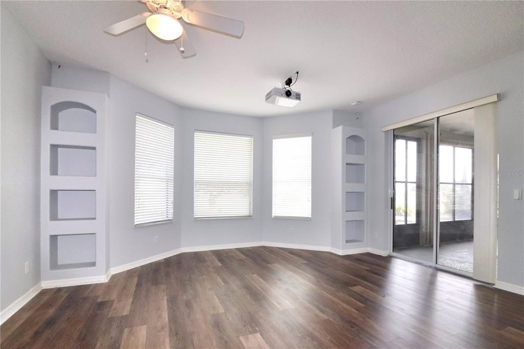 Master suite with projection TV system, built-in shelving and two walk-in closets