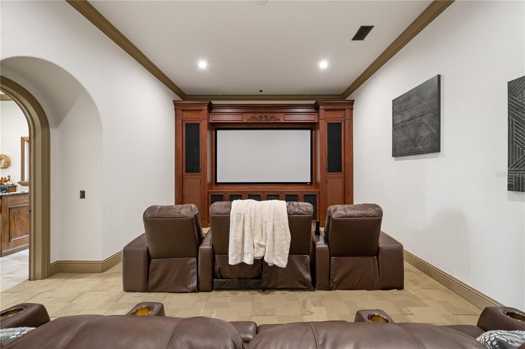 Home Theater is a classic style tucked away on the main floor  with two entry doorways
