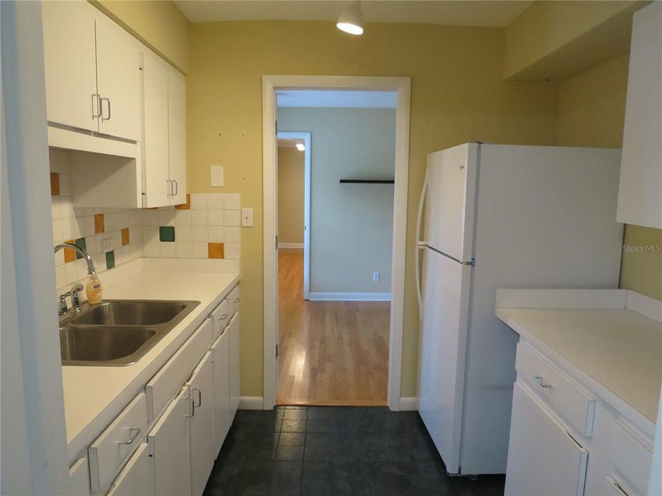 Kitchen with refrigerator looking into Room 2