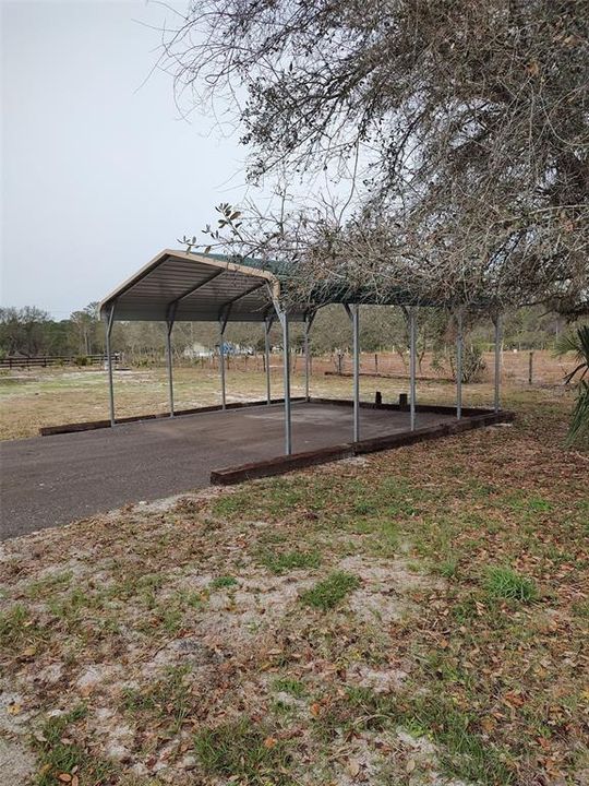 metal carport with paved surface