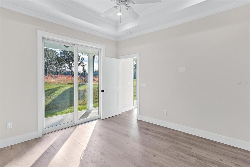 Primary Bedroom with Glass Sliding Doors giving access to Back Porch