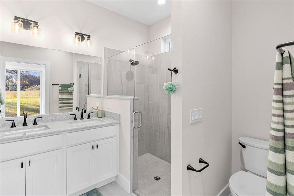 Primary Bathroom with Raised Vanity, Dual Sinks and Large Glass Walk-in Shower