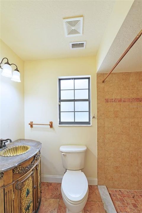 Guest bathroom with a walk-in shower off the laundry room